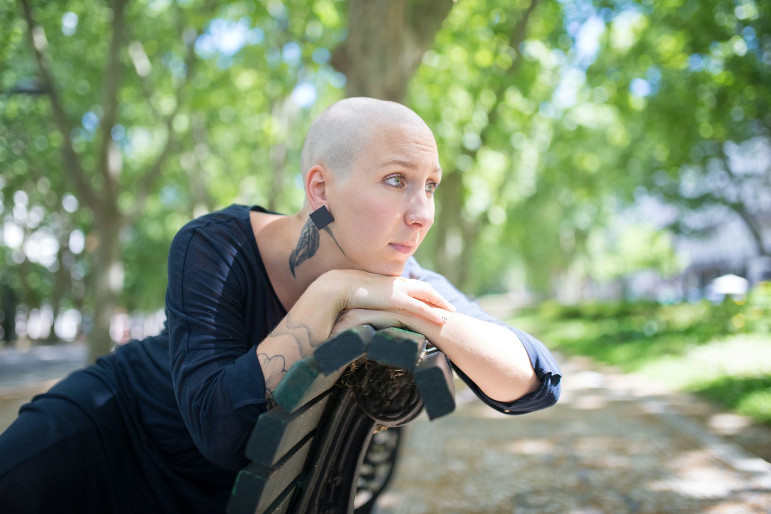 Bald Woman Sitting on Wooden Bench